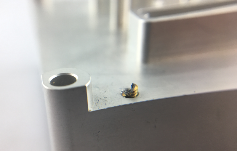 Due to the incomplete residue removal of thread tapping process, the tapping breaks in M2 blind hole of the aluminum alloy component. Using fluteless tapping could be an alternative here.
